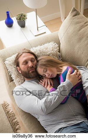 Father and daughter sleeping on couch View Large Photo Image Stock Photograph - Father and daughter sleeping on couch. Fotosearch