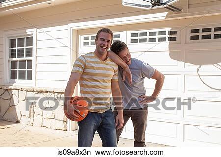 Father leaning on adult son's shoulder with basketball View Large Photo Image Picture - Father leaning on adult son's shoulder with basketball. Fotosearch