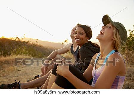Friends enjoying hillside View Large Photo Image Picture - Friends enjoying hillside. Fotosearch