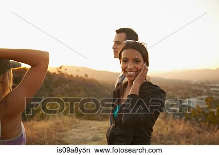 Picture - Friends enjoying hillside. Fotosearch