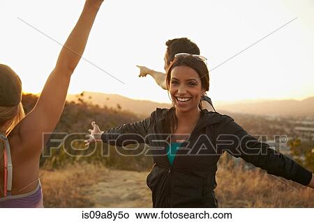 Picture - Friends enjoying hillside. Fotosearch