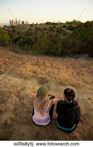 Friends enjoying hillside View Large Photo Image Stock Image - Friends enjoying hillside. Fotosearch