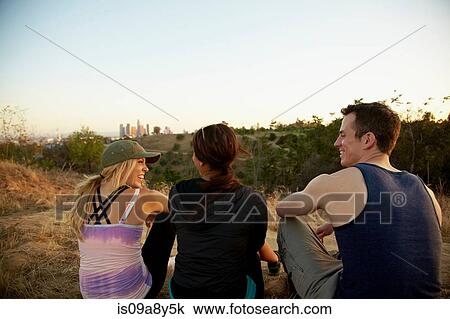 Stock Image - Friends enjoying hillside. Fotosearch
