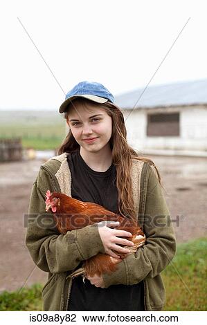 Girl carrying hen View Large Photo Image Stock Image - Girl carrying hen. Fotosearch
