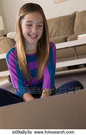 Girl looking at laptop View Large Photo Image Stock Image - Girl looking at laptop. Fotosearch