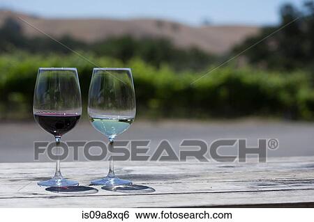 Stock Photograph - Glasses of red and white wine, close-up. Fotosearch