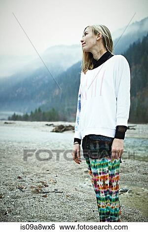 Stock Photograph - Hippy woman standing in mountains. Fotosearch