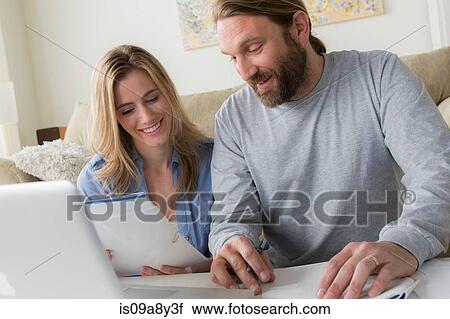Husband and wife looking at letter View Large Photo Image Stock Image - Husband and wife looking at letter. Fotosearch