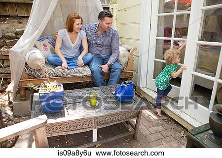 Husband & wife looking at child View Large Photo Image Stock Photograph - Husband & wife looking at child. Fotosearch