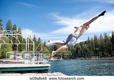Stock Photo - Man diving off jetty. Fotosearch