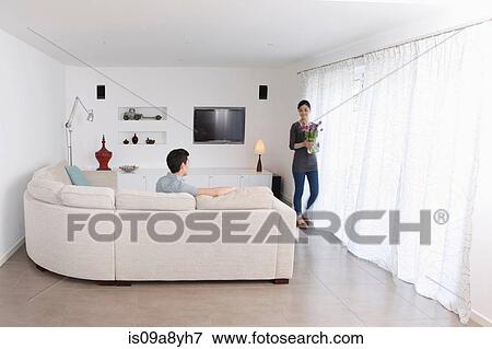 Man looking at woman walking away with vase of flowers View Large Photo Image Stock Photo - Man looking at woman walking away with vase of flowers. Fotosearch