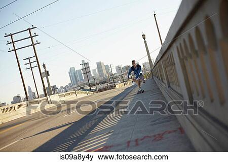 Man skateboarding on pedestrian walkway View Large Photo Image Stock Photo - Man skateboarding on pedestrian walkway. Fotosearch