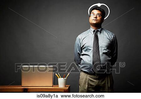Stock Image - Man with hands behind back looking angelic. Fotosearch