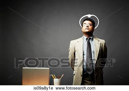 Stock Image - Man with hands behind back looking angelic. Fotosearch