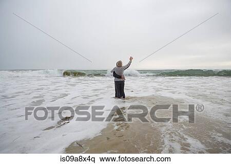 Stock Photography - Mature couple dancing on beach. Fotosearch