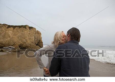 Mature couple kissing on beach View Large Photo Image Stock Photograph - Mature couple kissing on beach. Fotosearch