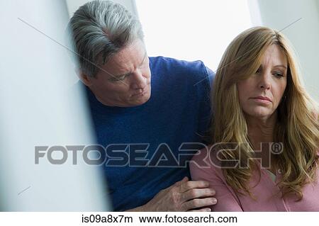 Mature man comforting mature woman View Large Photo Image Picture - Mature man comforting mature woman. Fotosearch