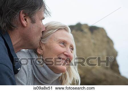 Mature man kissing mature woman's head, close-up View Large Photo Image Stock Image - Mature man kissing mature woman's head, close-up. Fotosearch