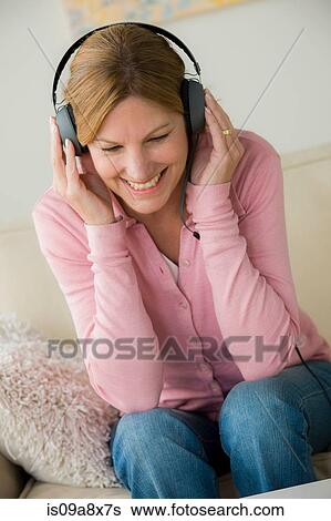 Mature woman wearing headphones, smiling View Large Photo Image Stock Photograph - Mature woman wearing headphones, smiling. Fotosearch