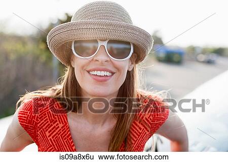 Mature woman wearing sunglasses and sunhat smiling towards camera View Large Photo Image Stock Photograph - Mature woman wearing sunglasses and sunhat smiling towards camera. Fotosearch