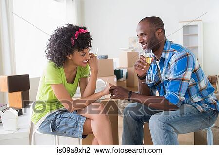 Mid adult couple in new home with champagne View Large Photo Image Stock Image - Mid adult couple in new home with champagne. Fotosearch