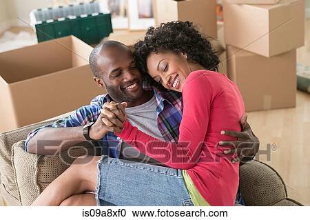 Mid adult couple on armchair in new home View Large Photo Image Stock Image - Mid adult couple on armchair in new home. Fotosearch