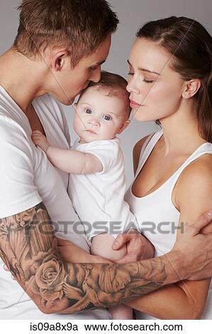 Stock Image - Mother and father with baby daughter. Fotosearch