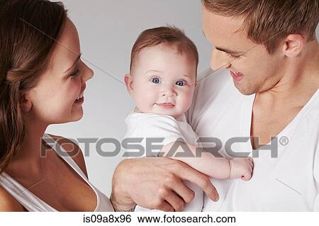 Mother and father with baby daughter View Large Photo Image Stock Photograph - Mother and father with baby daughter. Fotosearch