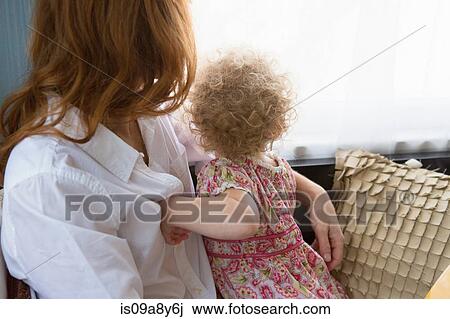 Mother & child looking out window View Large Photo Image Stock Image - Mother & child looking out window. Fotosearch