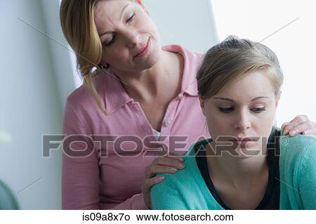Mother comforting teenage daughter View Large Photo Image Picture - Mother comforting teenage daughter. Fotosearch