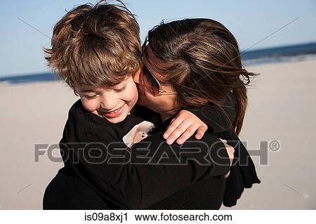 Mother kissing son on cheek View Large Photo Image Stock Image - Mother kissing son on cheek. Fotosearch