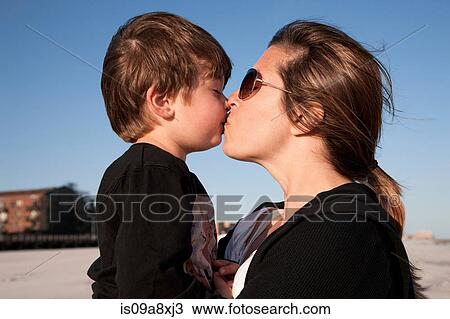 Mother kissing son View Large Photo Image Stock Image - Mother kissing son. Fotosearch