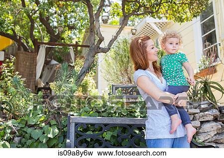 Mother looking at child in arms View Large Photo Image Stock Photo - Mother looking at child in arms. Fotosearch