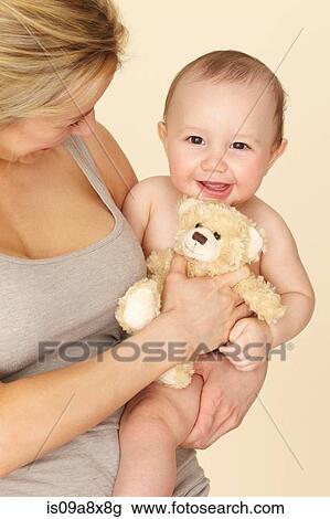 Stock Image - Mother with baby son and teddy bear. Fotosearch