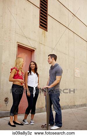 People chatting in back lane View Large Photo Image Stock Photo - People chatting in back lane. Fotosearch