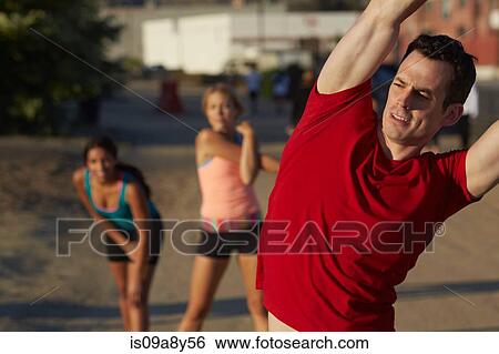 Stock Photograph - People doing stretching exercise. Fotosearch