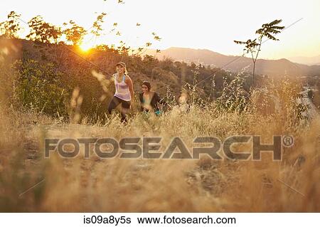 People walking up hillside path View Large Photo Image Stock Photograph - People walking up hillside path. Fotosearch