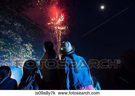 Stock Image - People watching fireworks display. Fotosearch