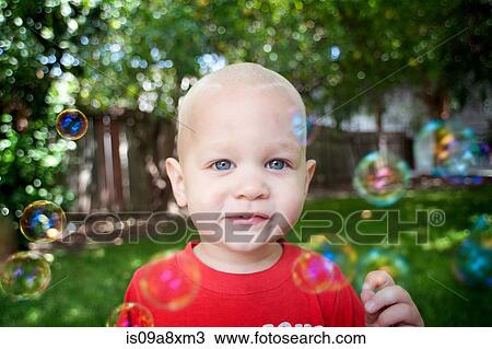 Portrait of baby boy with bubbles looking at camera View Large Photo Image Stock Image - Portrait of baby boy with bubbles looking at camera. Fotosearch