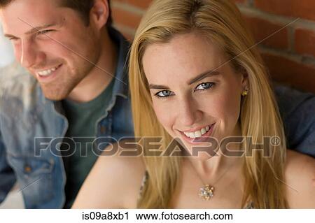 Portrait of couple, focus on young woman smiling View Large Photo Image Stock Image - Portrait of couple, focus on young woman smiling. Fotosearch