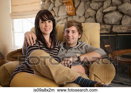 Portrait of couple sitting on armchair View Large Photo Image Picture - Portrait of couple sitting on armchair. Fotosearch
