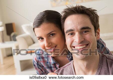 Stock Image - Portrait of couple smiling towards camera. Fotosearch