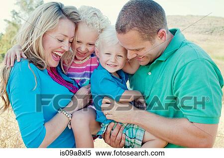 Portrait of family with two children laughing View Large Photo Image Stock Photography - Portrait of family with two children laughing. Fotosearch