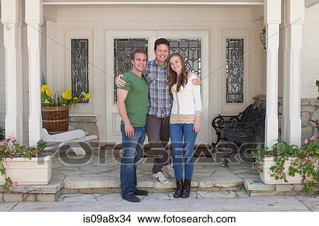 Portrait of father with adult offspring standing outside house View Large Photo Image Picture - Portrait of father with adult offspring standing outside house. Fotosearch
