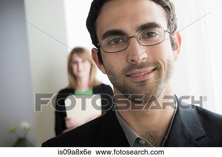 Stock Image - Portrait of male office worker wearing glasses. Fotosearch