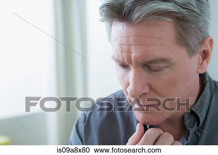 Portrait of mature man with hand on chin View Large Photo Image Stock Image - Portrait of mature man with hand on chin. Fotosearch