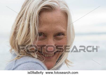 Portrait of mature woman smiling towards camera View Large Photo Image Stock Photo - Portrait of mature woman smiling towards camera. Fotosearch