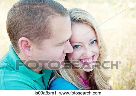 Stock Image - Portrait of mid adult couple, woman smiling. Fotosearch