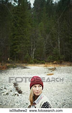 Stock Image - Portrait of woman in remote setting. Fotosearch