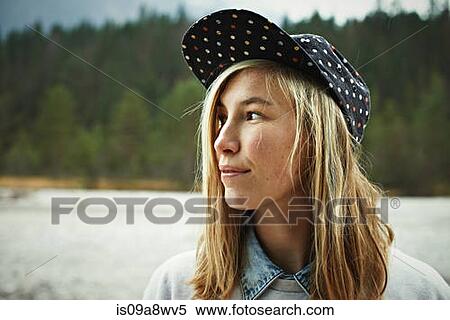 Stock Photography - Portrait of woman wearing cap headwear. Fotosearch